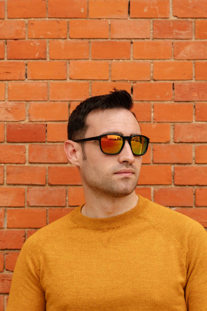 istock Portrait of handsome Hispanic man using his mobile with sunglasses. 1311500841