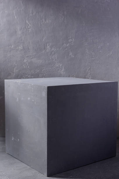 istock Grey or gray cube table near painted background texture. Abstract concept of modern minimalism design 1311501024