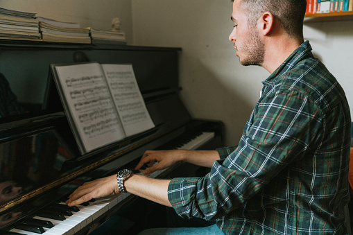 Young adult singer pianist exercising at home