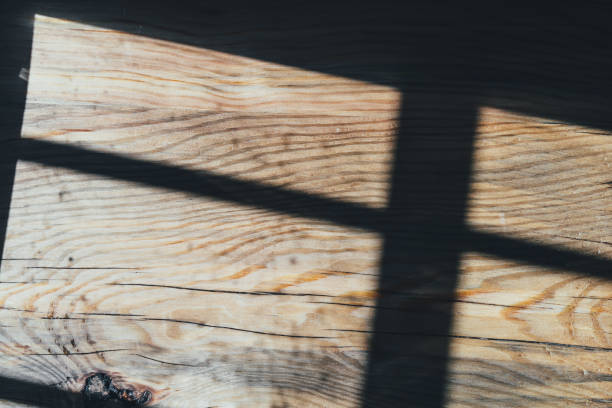 istock Wooden background with shadows and sunbeams from the window 1311501685