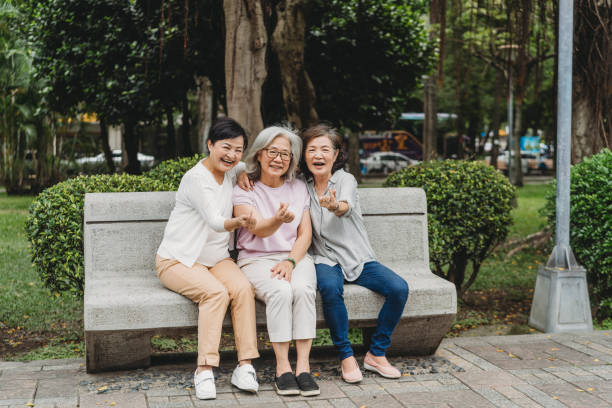 istock Three ladies sitting on a bench at the park together 1311501807