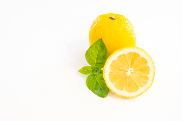 Istanbul, Turkey-May 4, 2021: Lemons scattered from a yellow shopping net on a black wooden background. Full Frame, Still life, Flat lay. Shot with Canon EOS R5.
