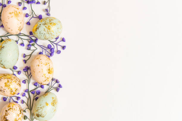 istock Colorful Easter eggs with spring blossom flowers isolated on white background and copy space on right side 1311503017