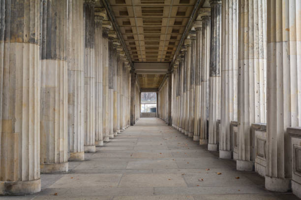 row of classic greek columns in berlin, germany - klasik stil stok fotoğraflar ve resimler