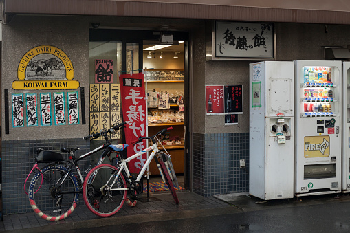 Horizontal shot of two bicycles parked in front of a corner store in Yanaka Ginza, Tokyo