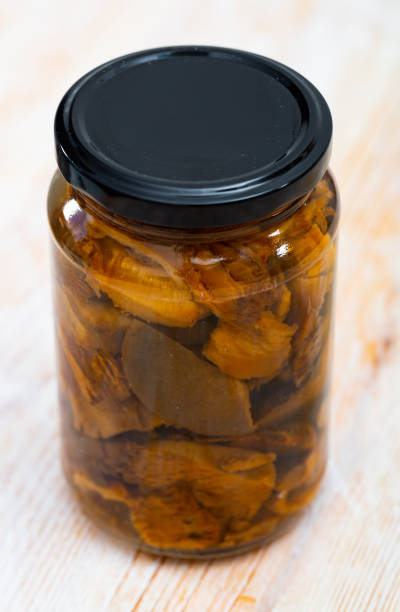 istock Closed glass jar with pickled lactarius deliciosus 1311505576
