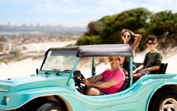 istock Dad driving his two children around in a beach buggy 1311505792
