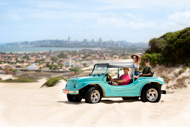 istock Smiling dad driving his children around in a beach buggy 1311505836