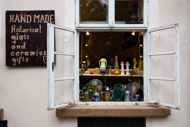 September 12, 2012: Small shop selling handmade glass and ceramics gifts on display in old open window, Prague, Czech Republic
