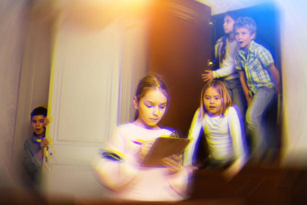 istock Focused tween girl solving conundrum to get out of quest room, toned image 1311507512