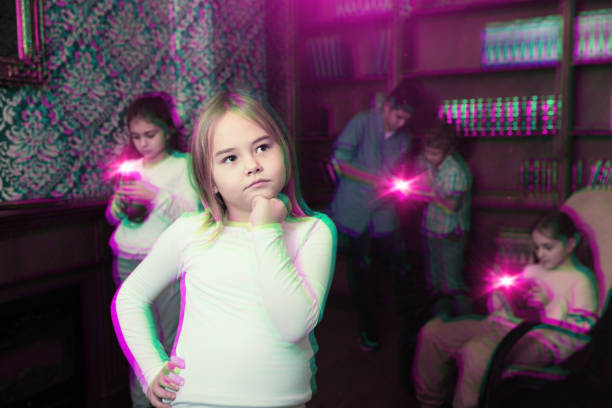 istock Pensive tween girl solving riddles in quest room, toned image 1311507527