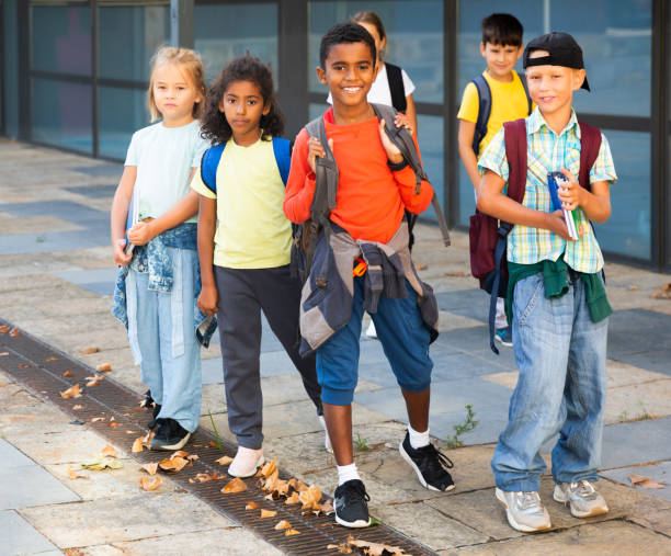 istock Group of children walking near school 1311509146