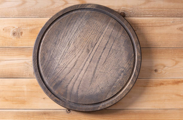 istock Meat or bread pizza cutting board for homemade baking on table. Pizza board at  wooden table background texture 1311509885
