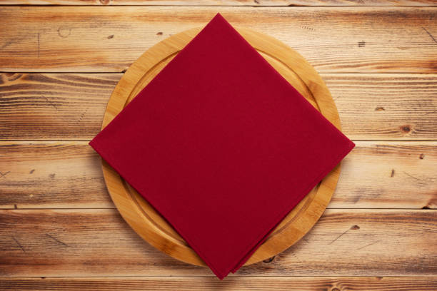 istock Table cloth napkin and pizza cutting board on wooden background texture 1311509919