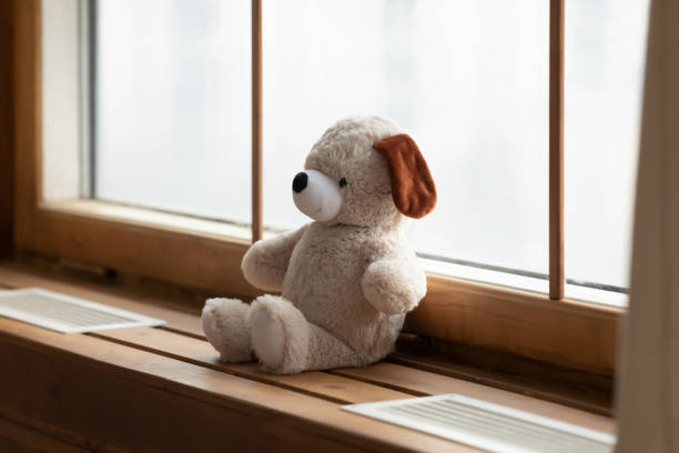 istock Plush teddy bear on windowsill in hospital 1311511319