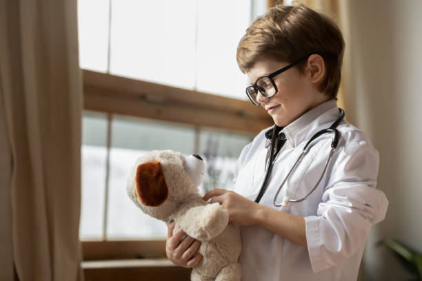 istock Small little boy in whites play as doctor 1311511320