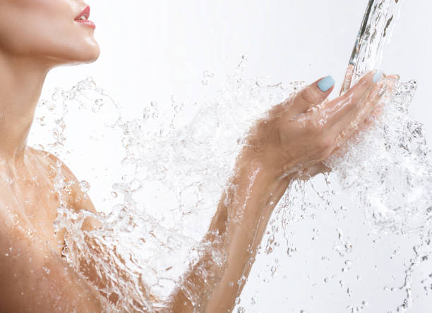 istock Young happy girl catching water stream in hands 1311511677