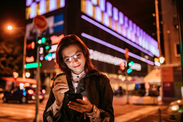 istock Woman checking social media on phone downtown 1311512451