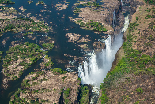 Aerial view of the world famous Victoria Falls. This is right at the border between Zambia and Zimbabwe in Southern Africa. The mighty Victoria Falls at Zambezi river are one of the most visited touristic places in Africa.