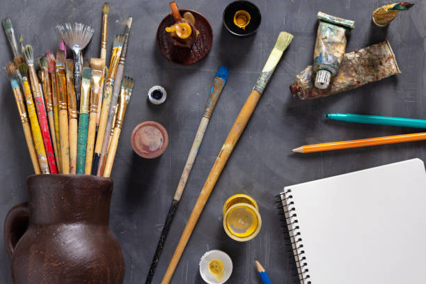 istock Paintbrush and tubes with painter tools at table background texture. Art painter concept and paint brush 1311514149