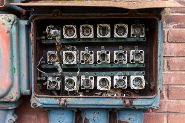 Old abandoned electric board at brick wall