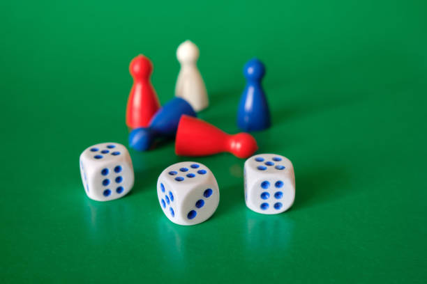 istock Colored game figures chips for board games. Collection of dice cubes on green table. 1311515141
