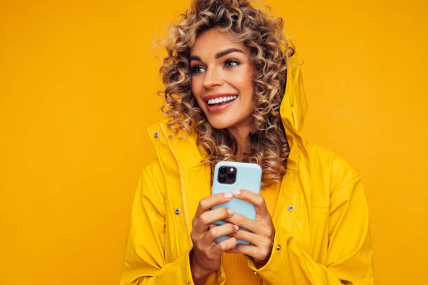 istock Beautiful smiling woman using smart phone 1311516437