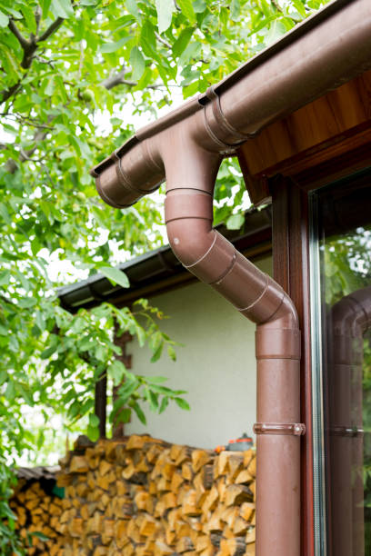 istock plastic gutter for draining rainwater at the corner of a building 1311517760