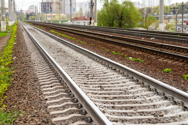 istock Railway rails in perspective to the city 1311518061