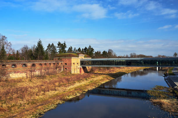 istock a modern footbridge and historic defensive walls on the Warta River 1311520497