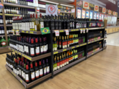 Stock with varieties of Brazilian wines in a supermarket. Blurred image.