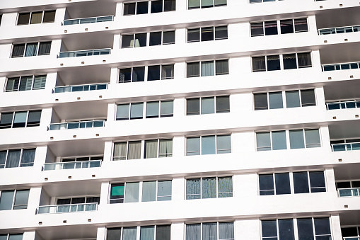 Abstract exterior architecture facade of art deco white vintage retro residential building or hotel with balconies