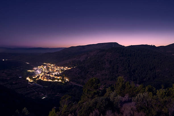 istock Small village in the mountains at night 1311527520