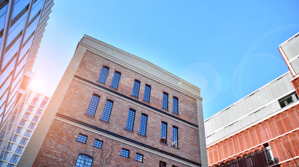 istock Revitalized red brick building and modern office building. 1311528765