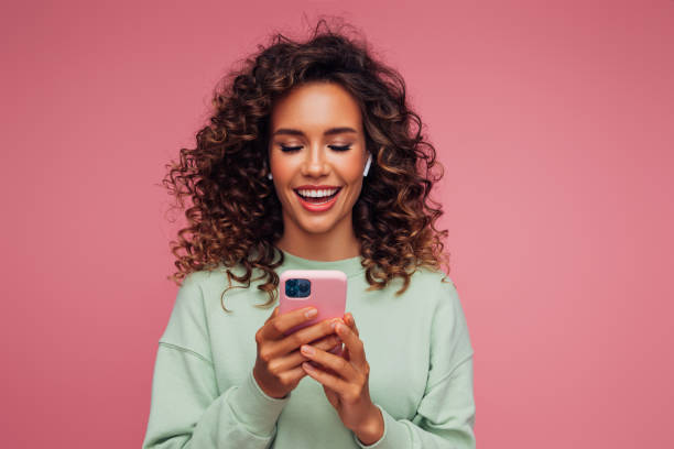 istock Beautiful woman with smart phone 1311529559