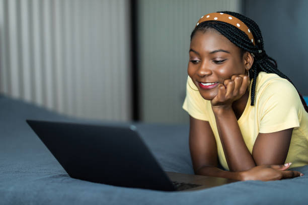 istock Woman lying on her belly using a laptop in her bedroom working from home in quarantine lockdown. Social distancing Self Isolation 1311530858