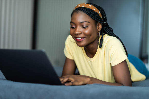 istock Pretty african woman using laptop in bed 1311531951