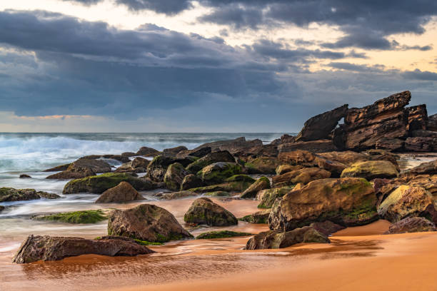 istock Sunrise seascape with rain clouds on the horizon 1311532029