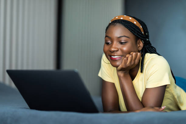 istock Pretty african woman using laptop in bed 1311532721