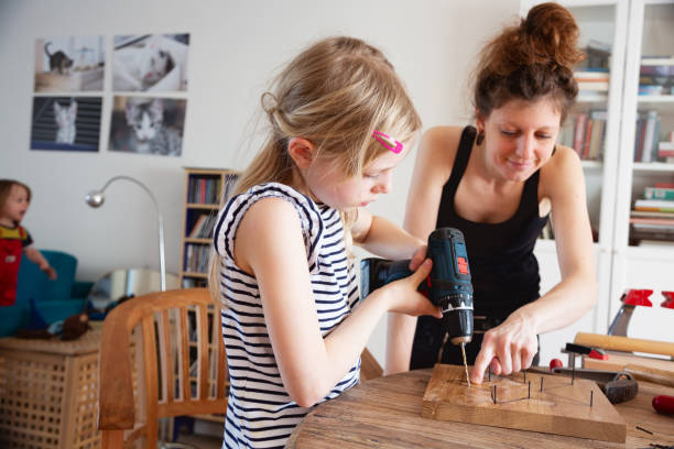 istock Mother teaching daughter DIY project with wood 1311534552