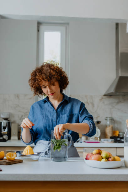 istock Beautiful Woman Preparing a Delicious Mint Lemonade 1311534918