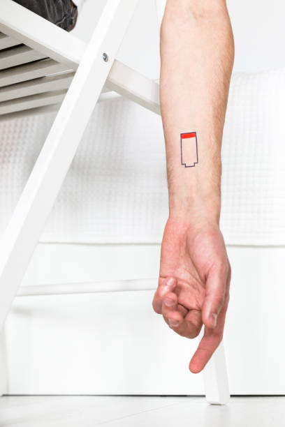 istock Low battery symbol drawn on human hand, chronic fatigue 1311535618