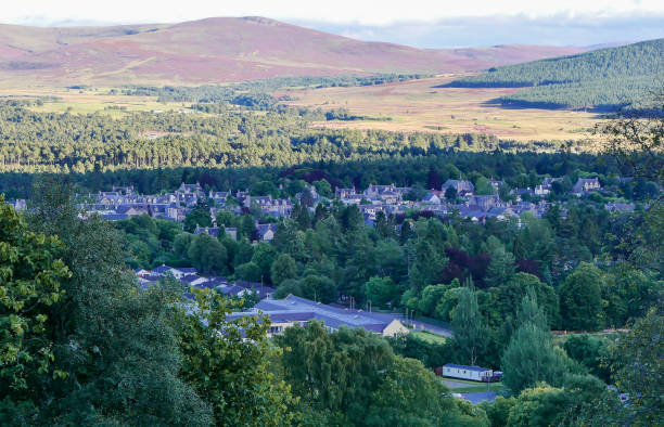 Scottish Highland town of Grantown-on-Spey Scottish Highland town of Grantown-on-Spey, on the northern edge of the Cairngorm mountains, viewed from nearby Gorton Hill. Evening sunlight shines over purple heather in bloom on the sides of the distant hills. moray firth stock pictures, royalty-free photos & images