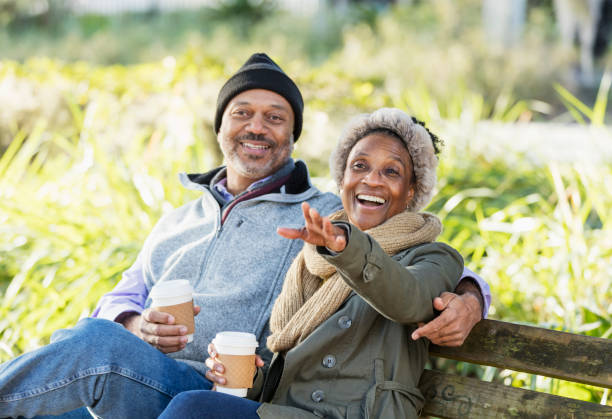 istock African-American relaxing on park bench drinking coffee 1311540349