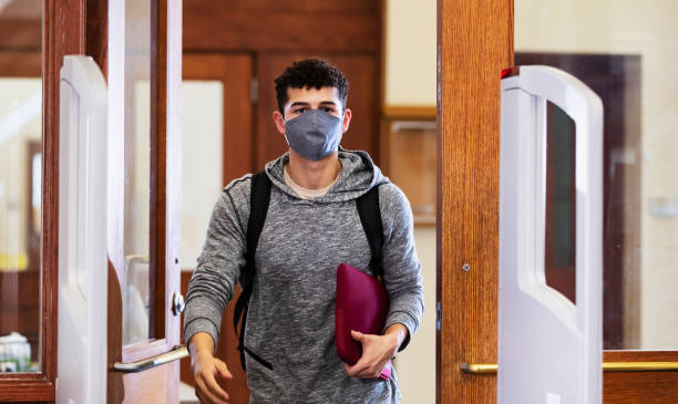 istock Man walking through door and anti-theft gate, face mask 1311544925