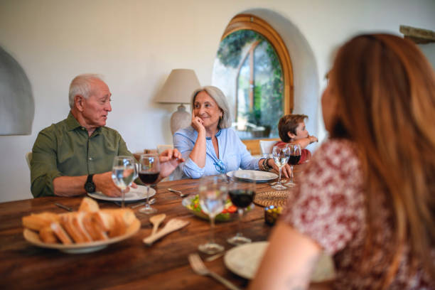 istock Family Members Sitting at Dining Table for Lunch 1311546276