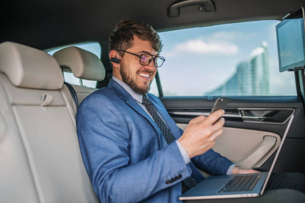 istock A handsome businessman using a phone while travel with car. 1311546370