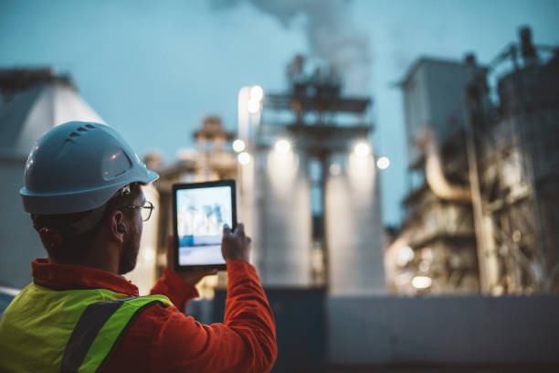 istock Serious handsome engineer using a digital tablet while working in the oil and gas industry. 1311546383