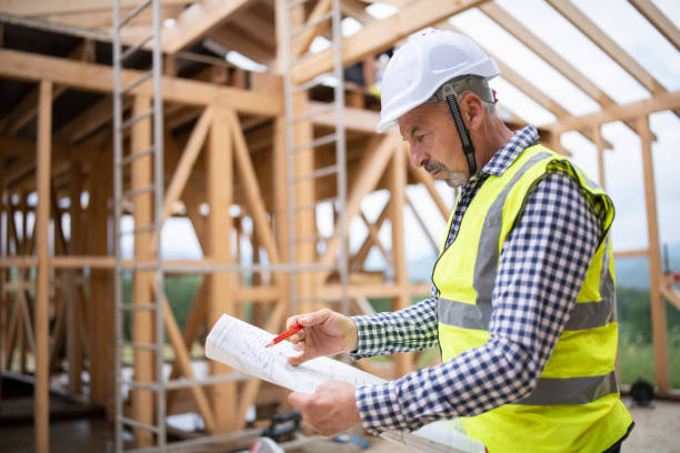 istock Portrait of a construction worker holding a floor plan. 1311546386