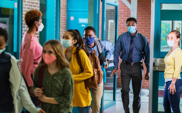 istock Parents drop middle school students off, with face masks 1311546639